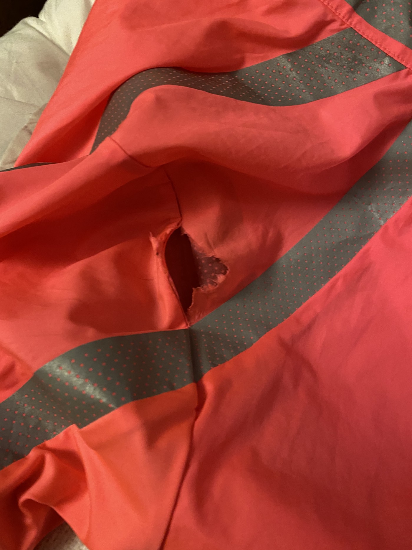 The shoulder of the jacket, with a big tear along the seam