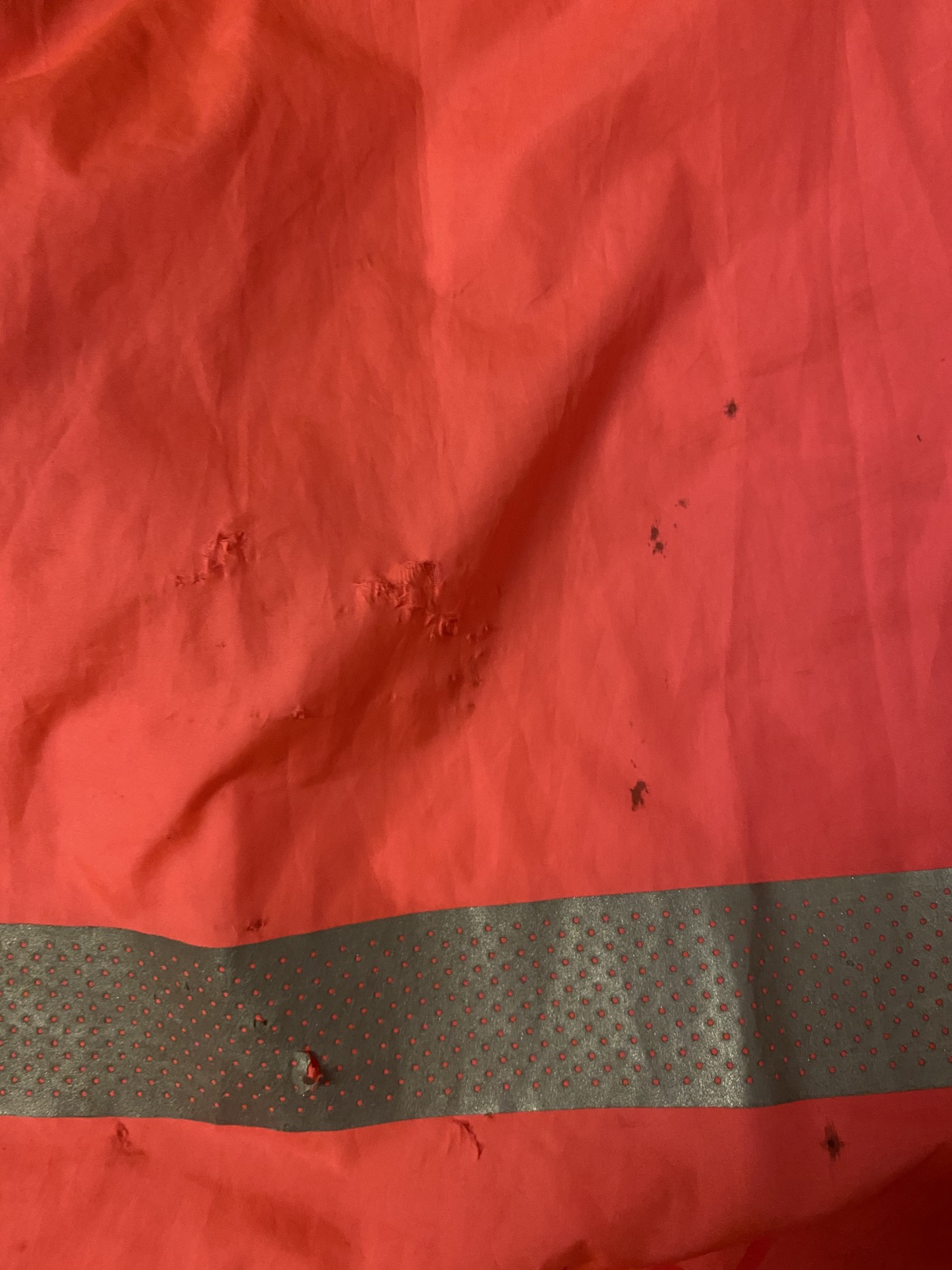 The back panel was grazed, with many tiny holes and a few you could almost poke a finger through.